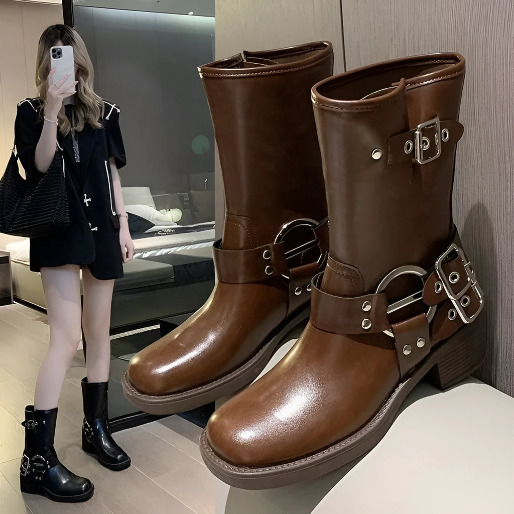 Black and brown women's platform boots with buckle details on the calf.