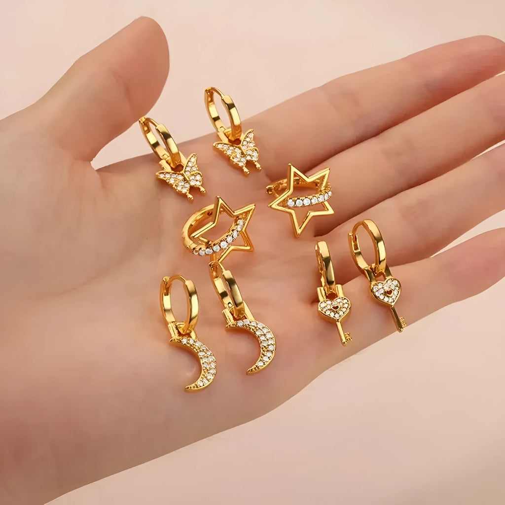 Butterfly-shaped copper earrings with geometric heart, star and bow patterns in metallic finish