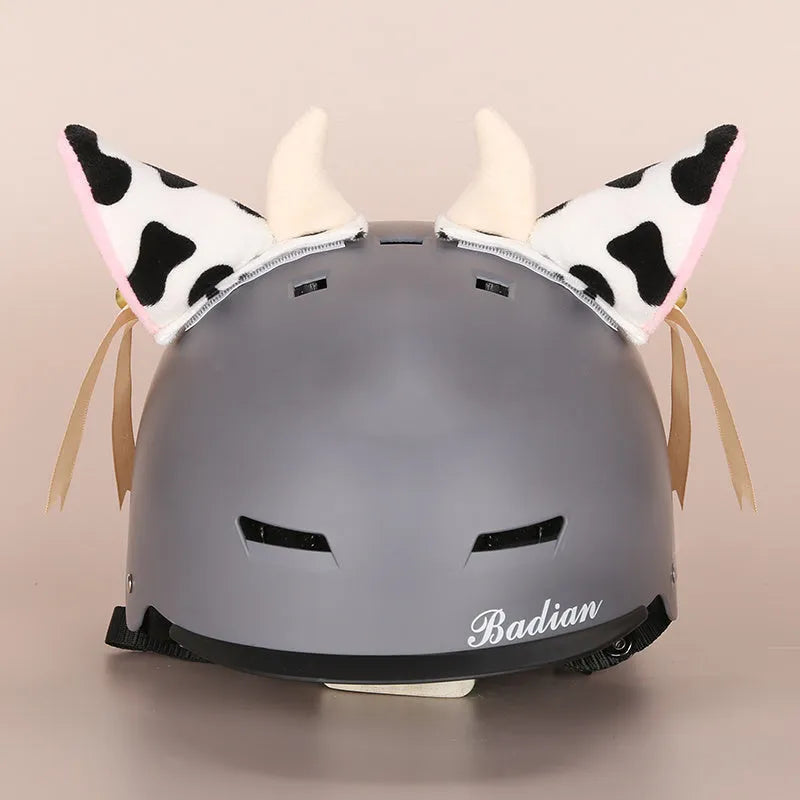 A plush fabric helmet cover with cartoon character ears, shown in size M for bicycle or motorbike use.