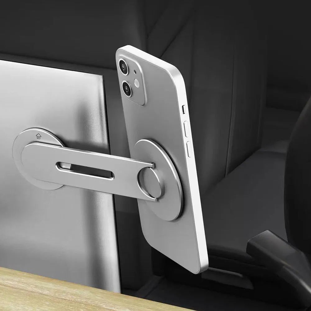 Silver aluminium magnetic car phone holder mounted on Tesla suspension screen showing 180-degree flip function
