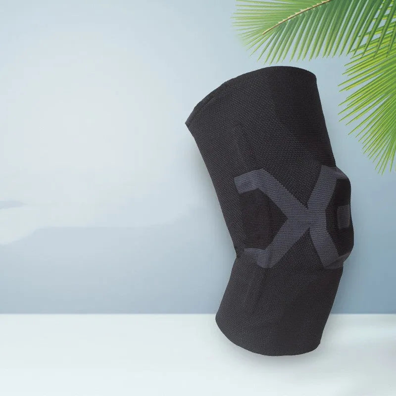 Silicone knee pad for men in black and blue colour, shown on a knee during activity.
