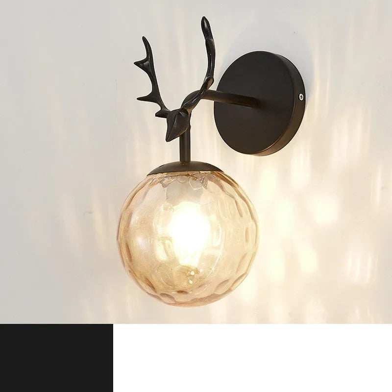 Nordic minimalist round glass wall lamp in golden finish mounted on a wall.