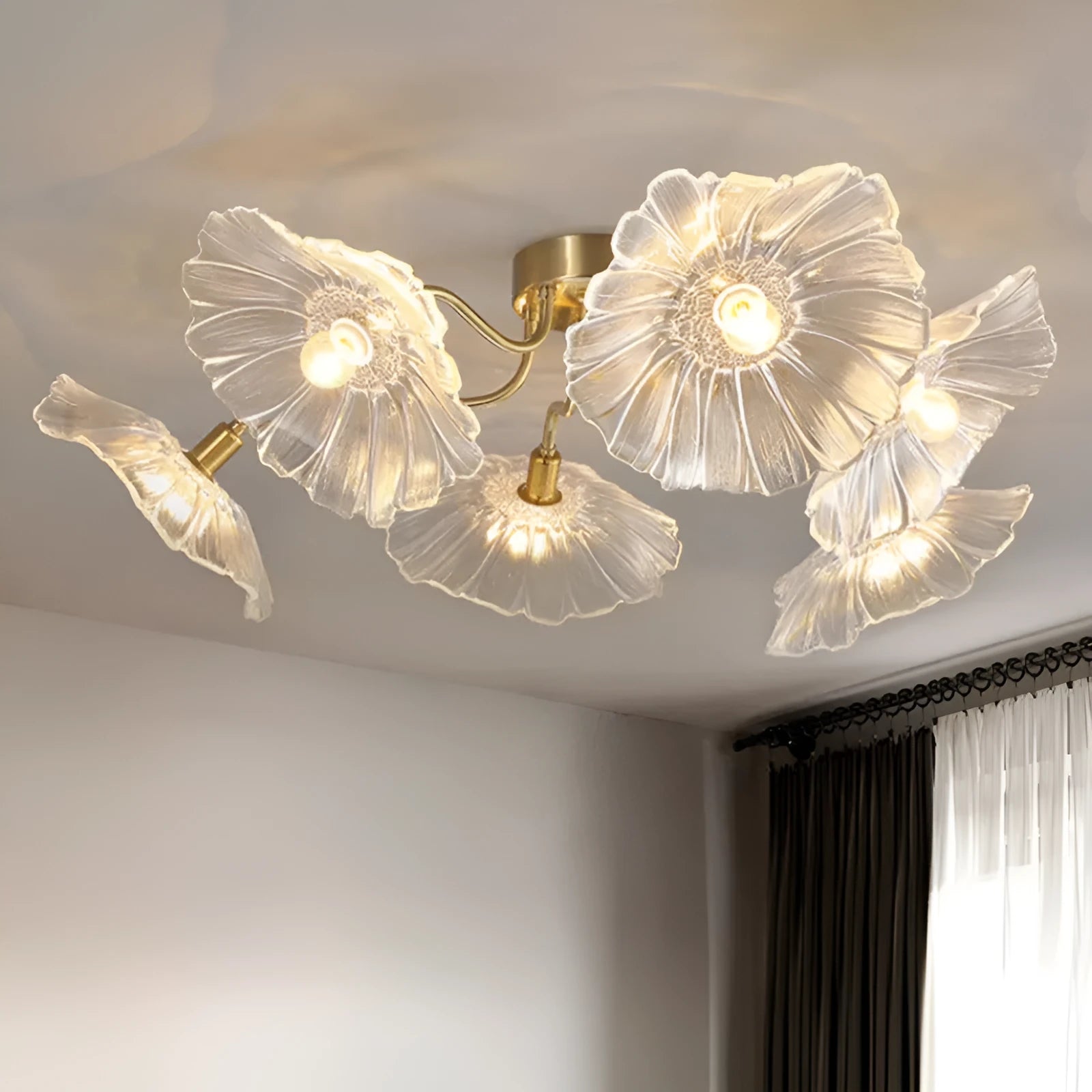 Modern white flower ceiling lamp with five light heads emitting a warm glow in a living room.