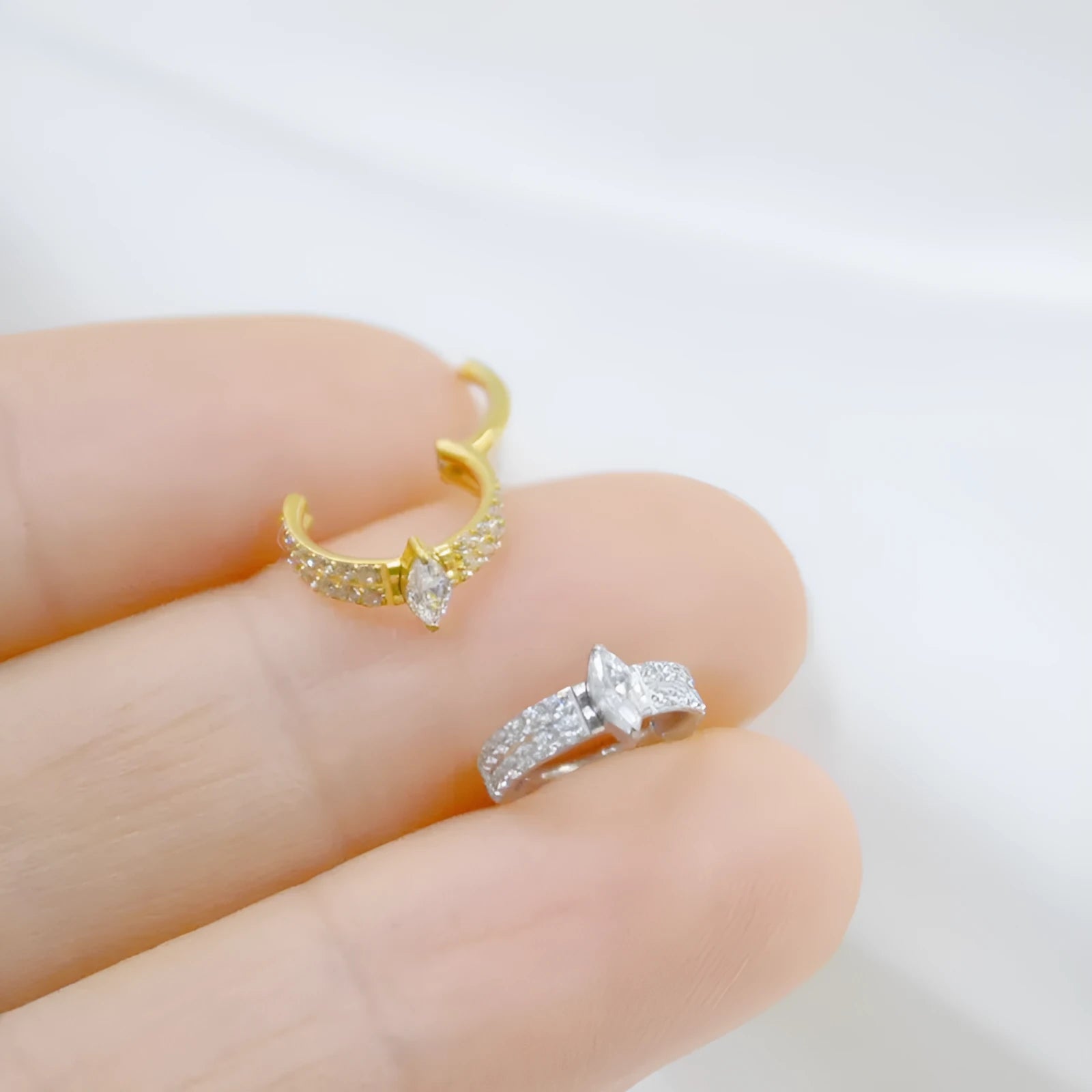 Titanium steel heart-shaped earrings with zircon stones in silver tone, showing post and butterfly back.