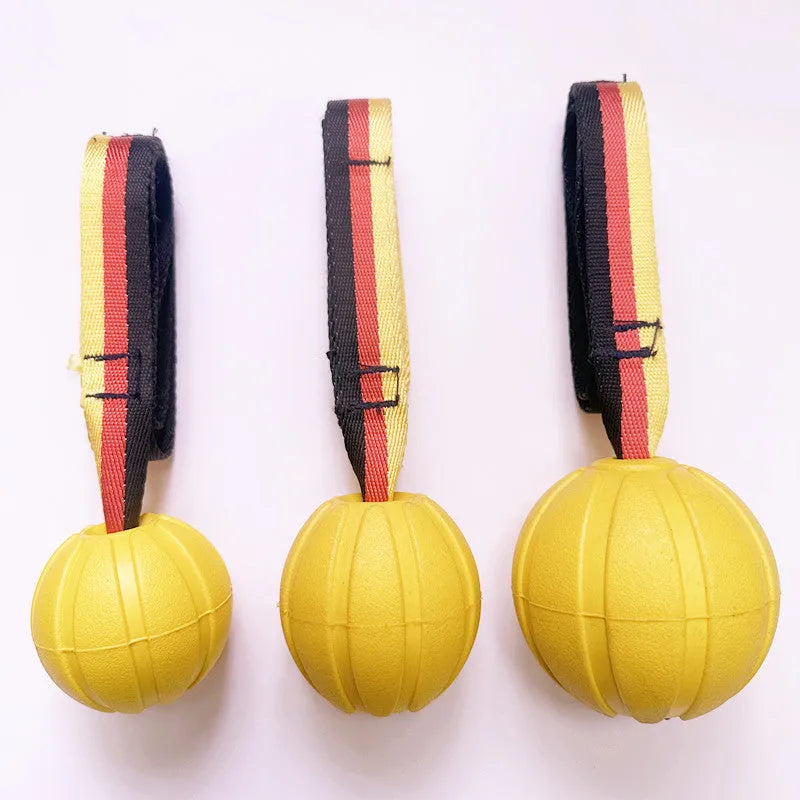 Yellow and camouflage floating EVA foam dog balls with tether strings in three different sizes on a blue background.