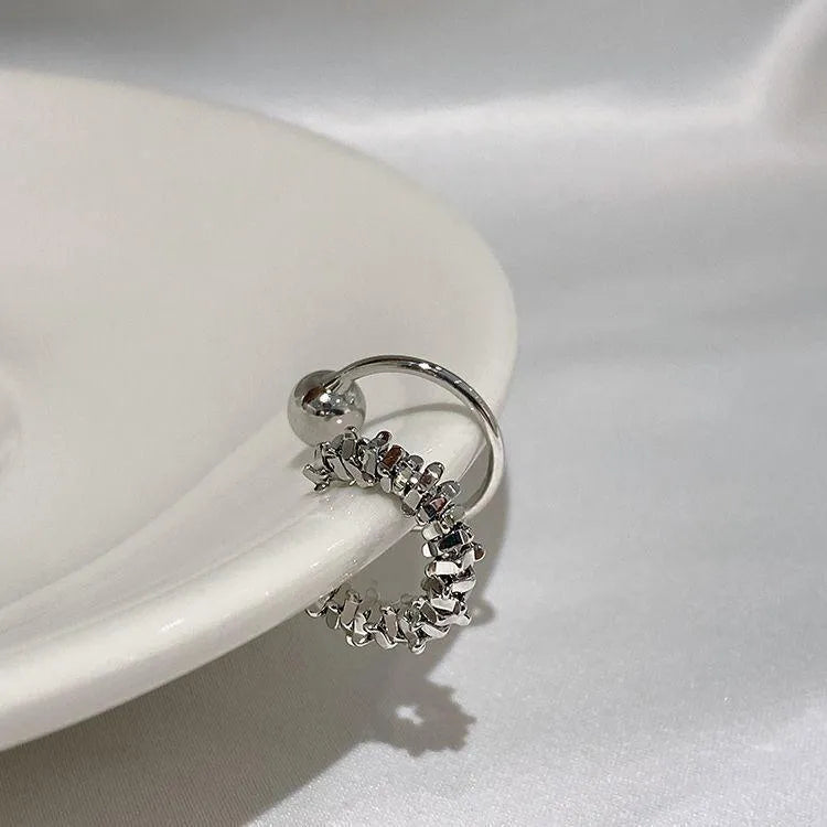 A pair of alloy clip-on earrings with an irregular geometric shape and frosty B4710 colour.