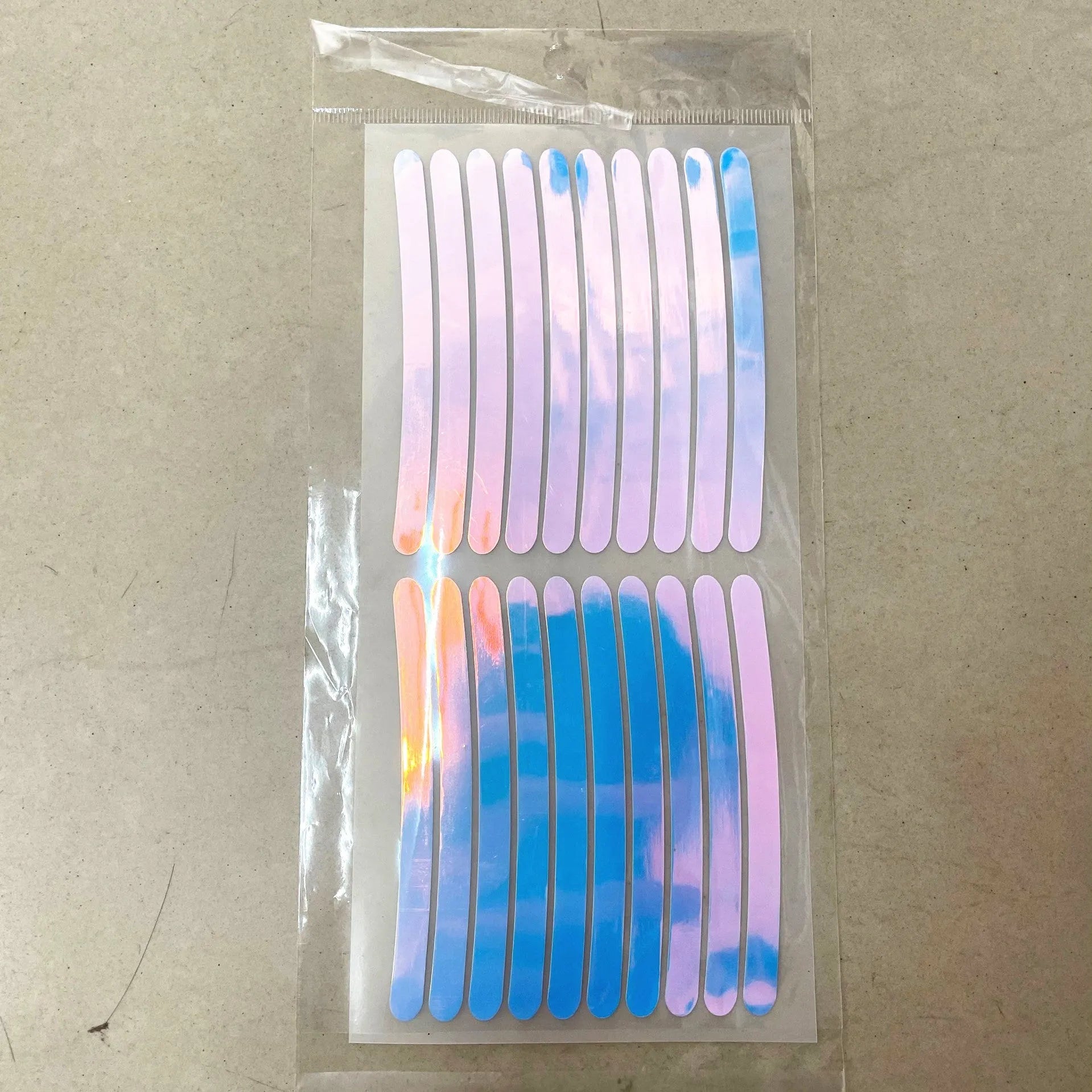 Pack of 20 arc-shaped reflective PVC stickers for car wheel hubs in multiple colours.