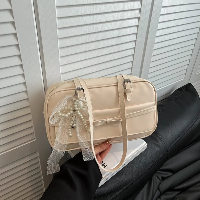 Women's black PU leather single shoulder flap bag with horizontal square shape and bow detail