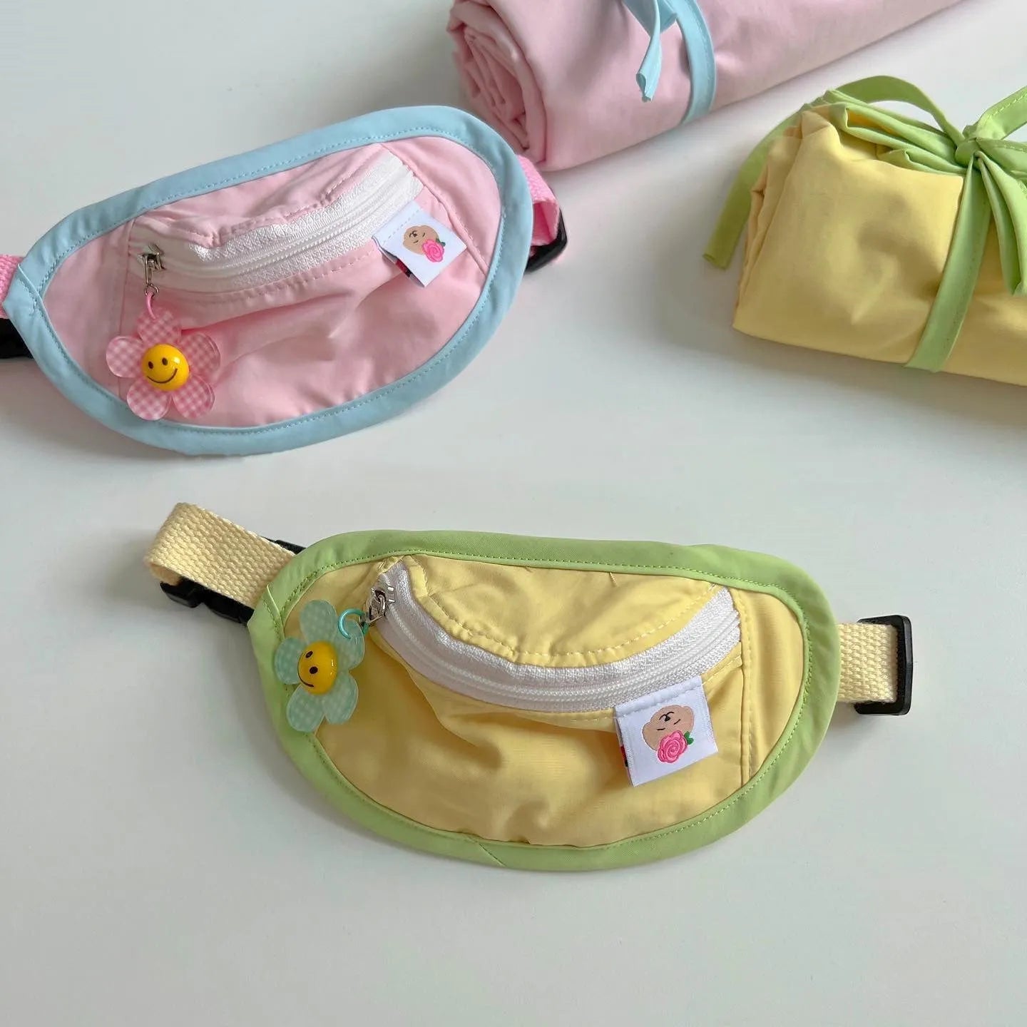 Pink, yellow, blue, and green pet carrier backpack for dogs and cats with adjustable sizing.