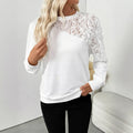 White floral pattern long sleeve pullover top on hanger showing loose fit design