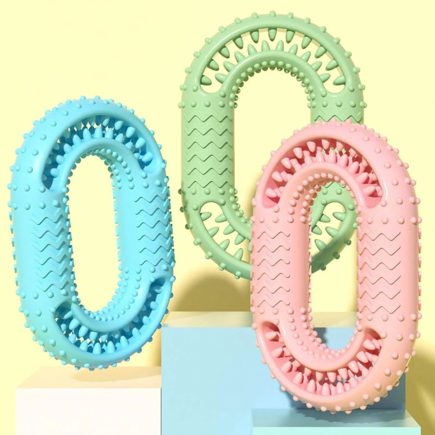 Blue, green, and pink O-ring shaped durable dog chew toy for aggressive chewers.