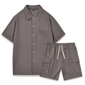 Women's beige elastic waist shorts and short sleeve top two-piece set laid flat.