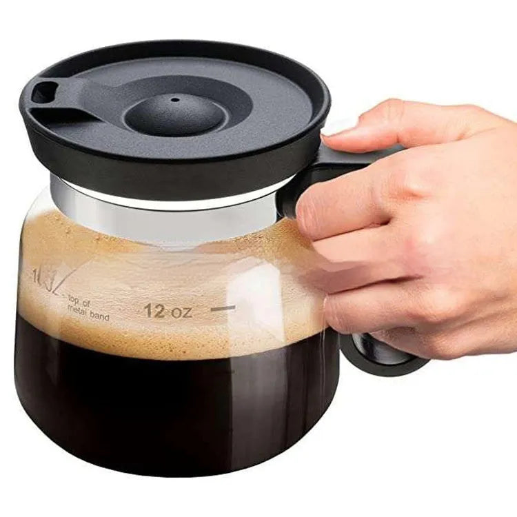Transparent borosilicate glass coffee maker with a black silicone cover, showing 355-473 ml capacity.