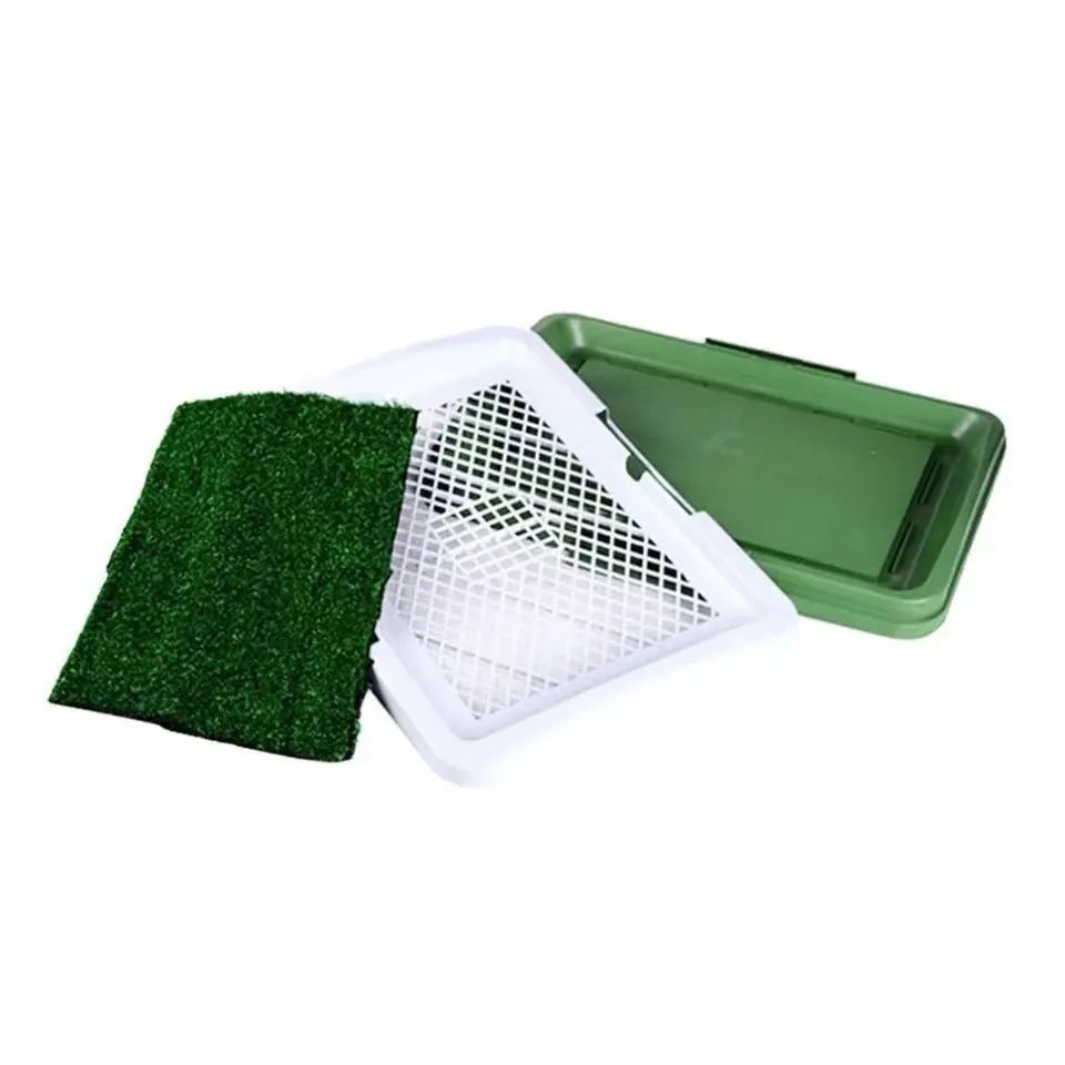 Green synthetic turf dog toilet trainer with three-layer plastic tray system for indoor use.