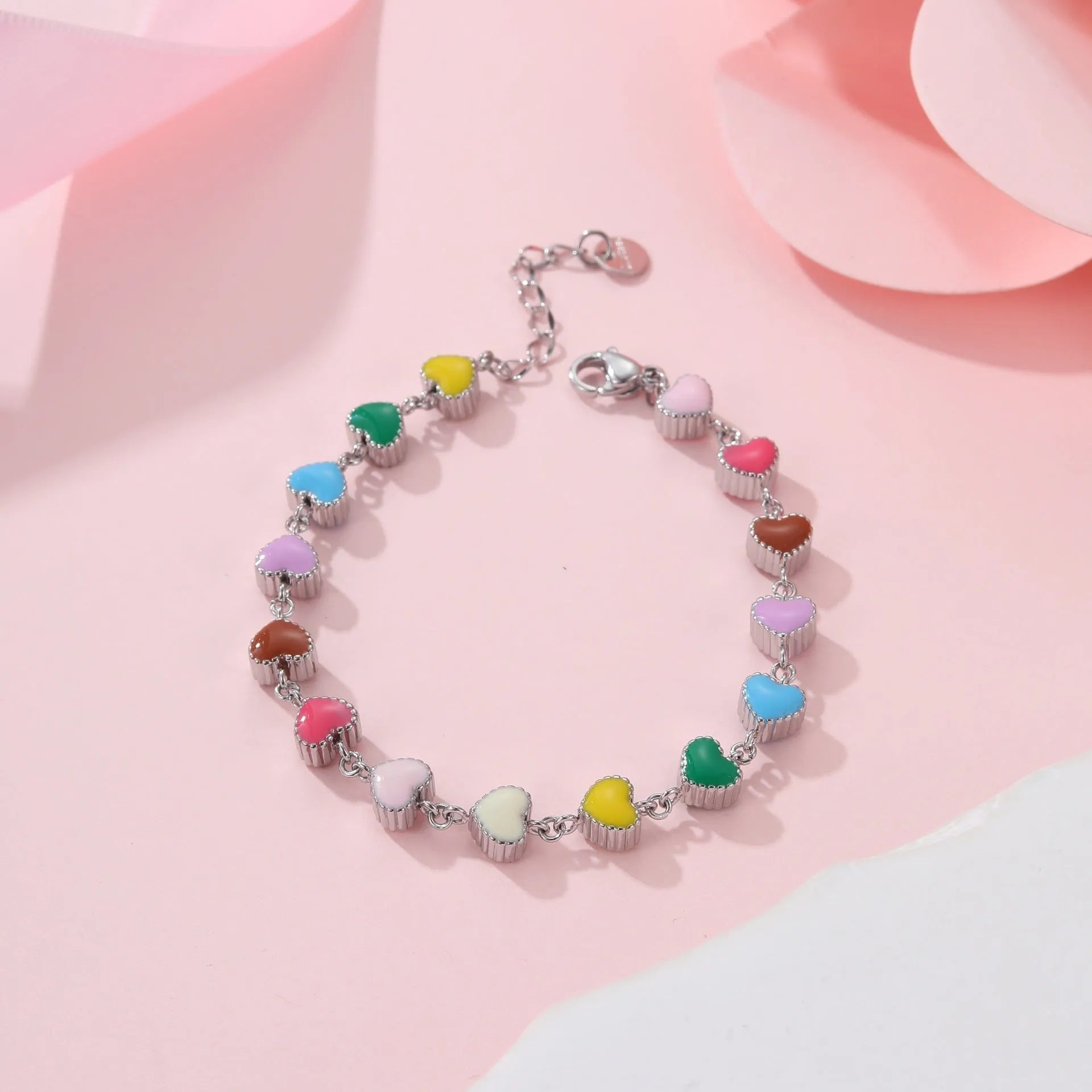 Close-up of a women's love heart-shaped bracelet in stainless steel with 18K gold plating.
