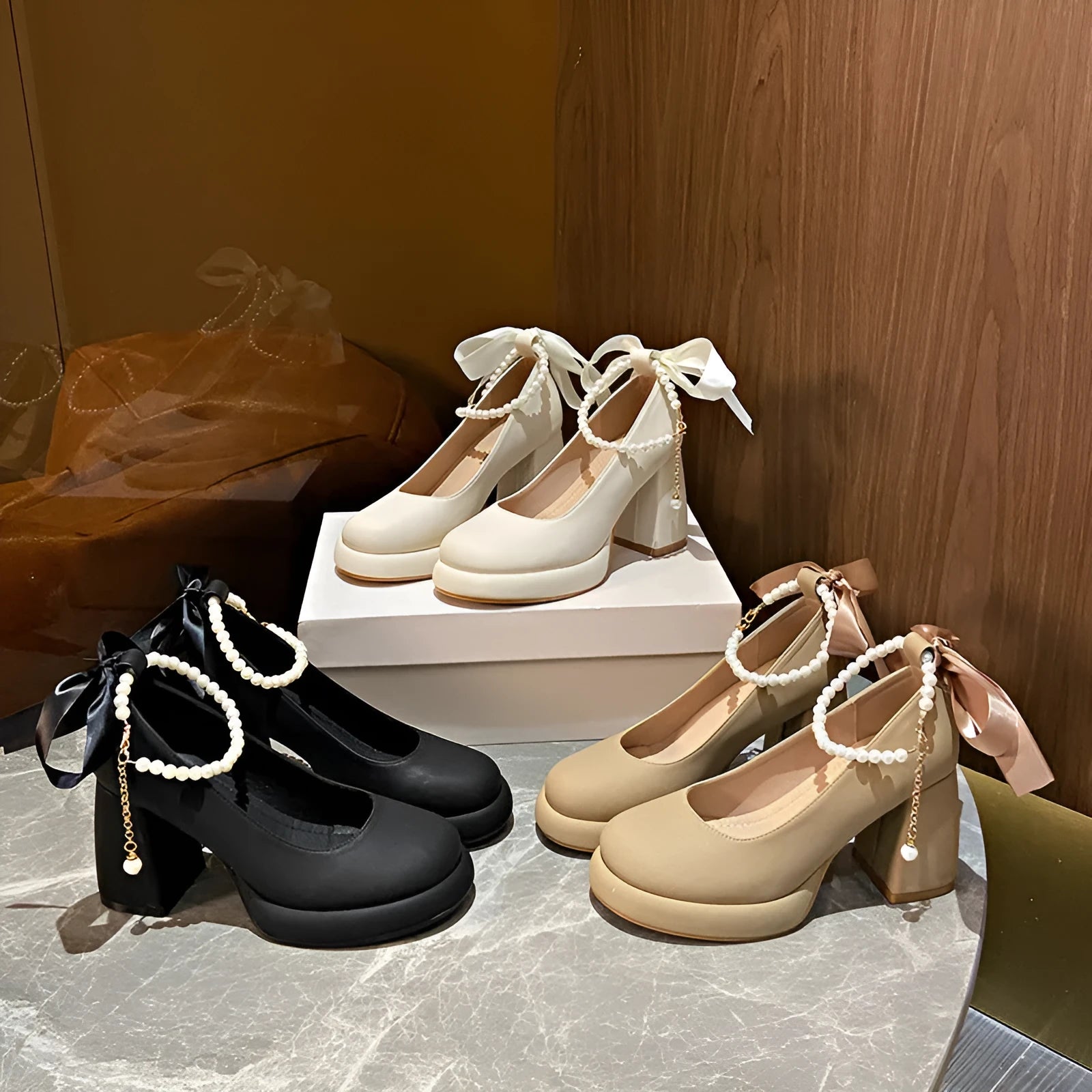 Women's beige Mary Jane shoes with a chunky heel and an ankle-strap buckle on a round toe.