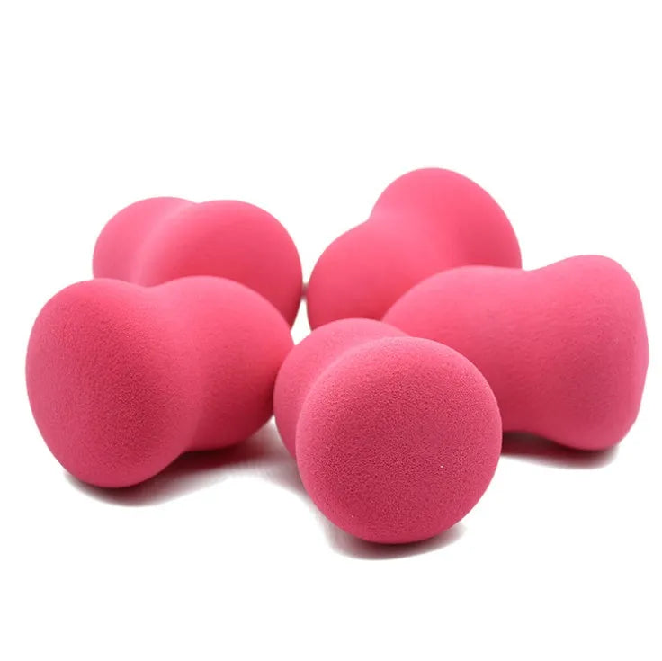 Pink non-latex makeup foundation sponge shown next to a ruler showing 4 cm width and 5.6 cm height
