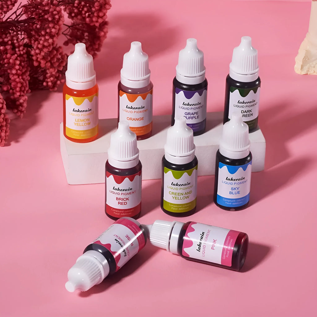 Set of 24 small bottles of craft pigment in various colours next to toy toolbox, boots, gloves, and other accessories.