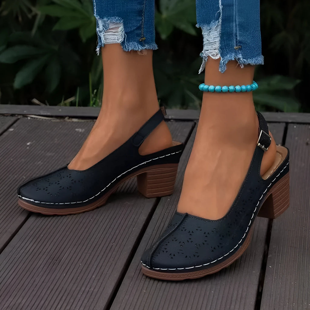 Women's closed toe wedge sandal in PU leather with a round toe and rubber wedge sole.