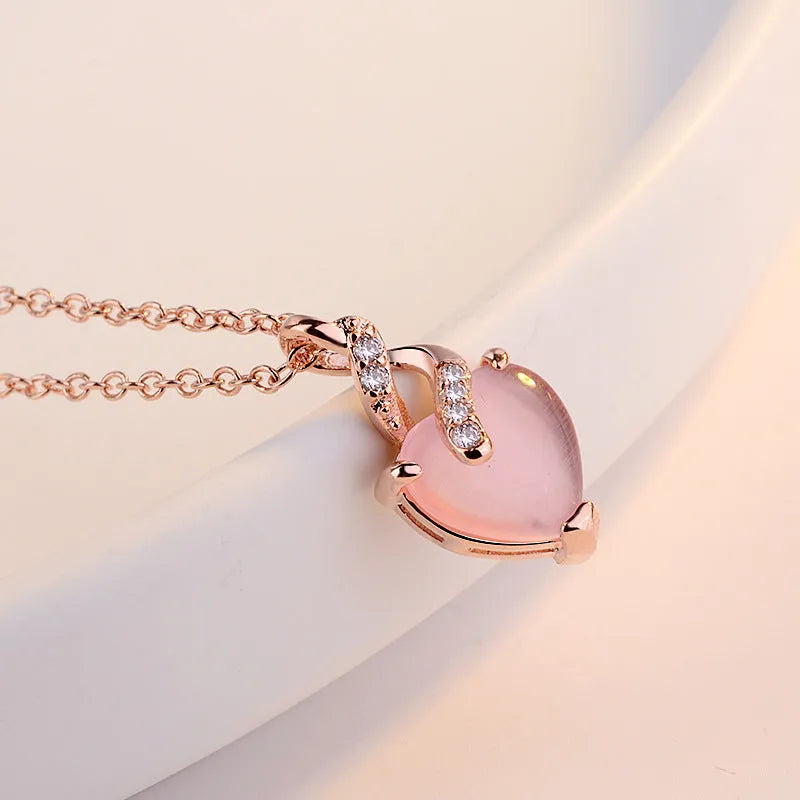 Rose gold electroplated heart-shaped crystal pendant necklace with cross chain design