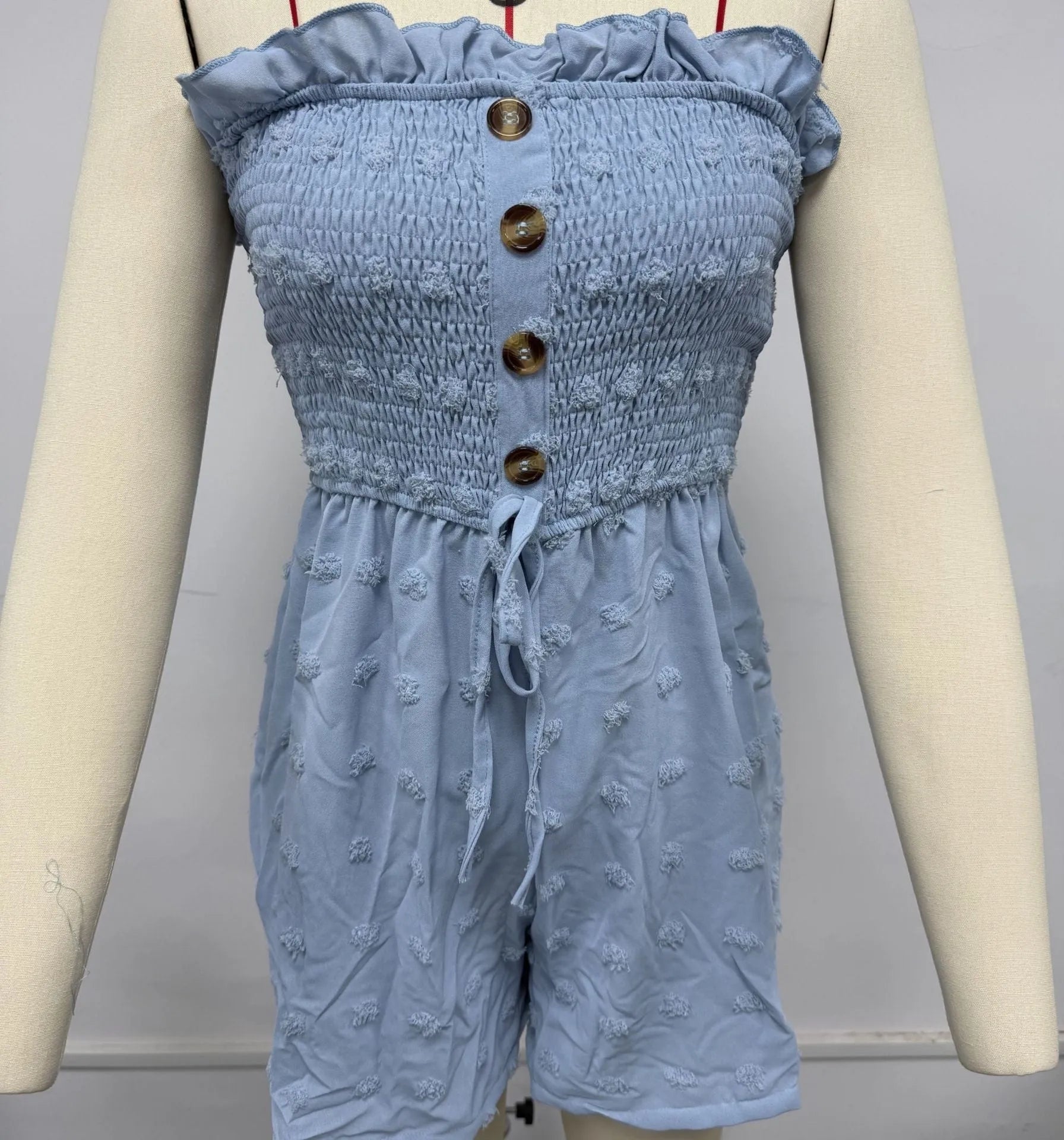 Women's solid colour off-shoulder sleeveless jumpsuit in blue showing Japanese Korean casual style with button detail