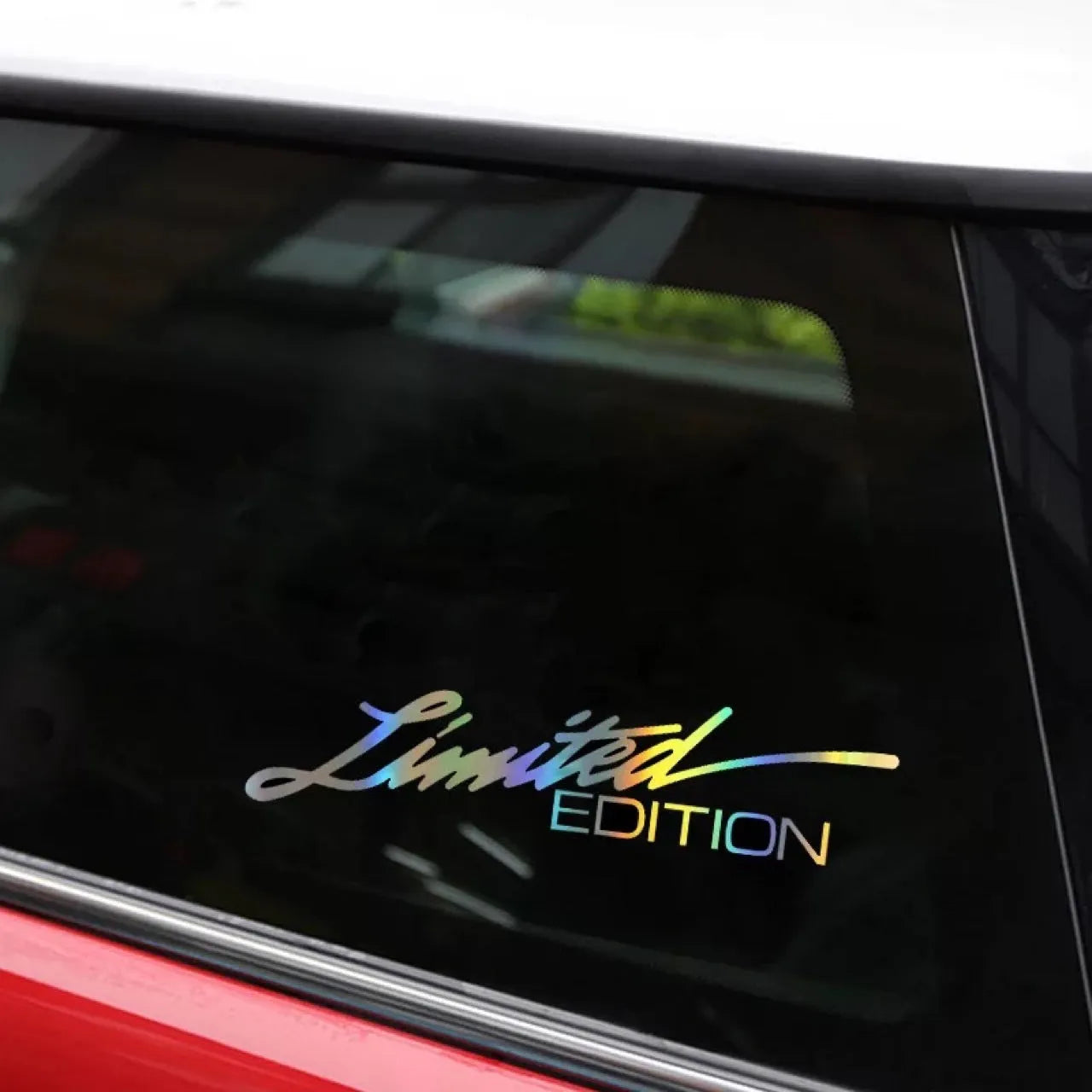 Black laser reflective text car sticker on a vehicle window.