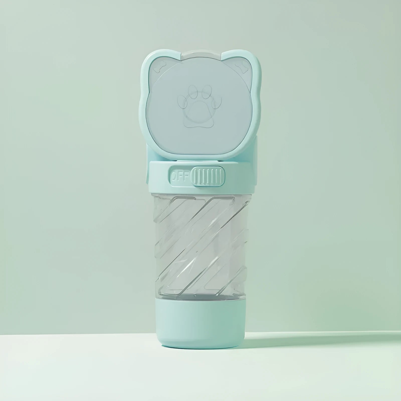 Green 3-in-1 pet water bottle with food container top and waste bag dispenser base, held by hand strap.