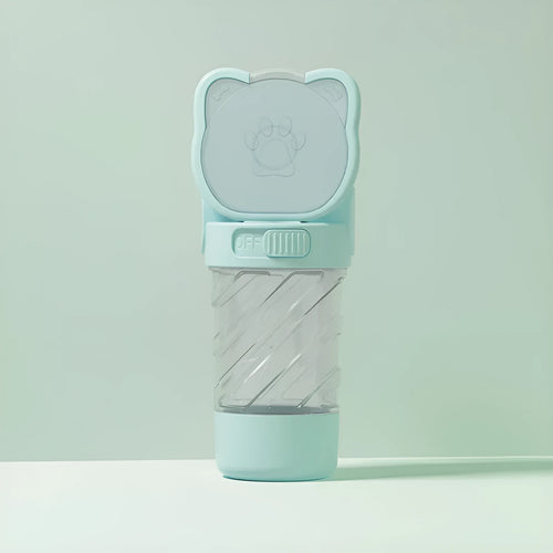 Green 3-in-1 pet water bottle with food container top and waste bag dispenser base, held by hand strap.
