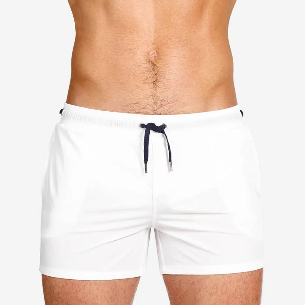 Men's solid colour polyester swimming shorts with mesh lining, shown in multiple colour options.