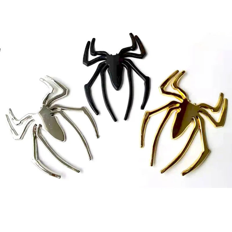 Three-dimensional metal spider bumper sticker in zinc alloy, shown in gold colour.