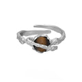 White gold coloured Saturn open ring with adjustable sizing on silver base