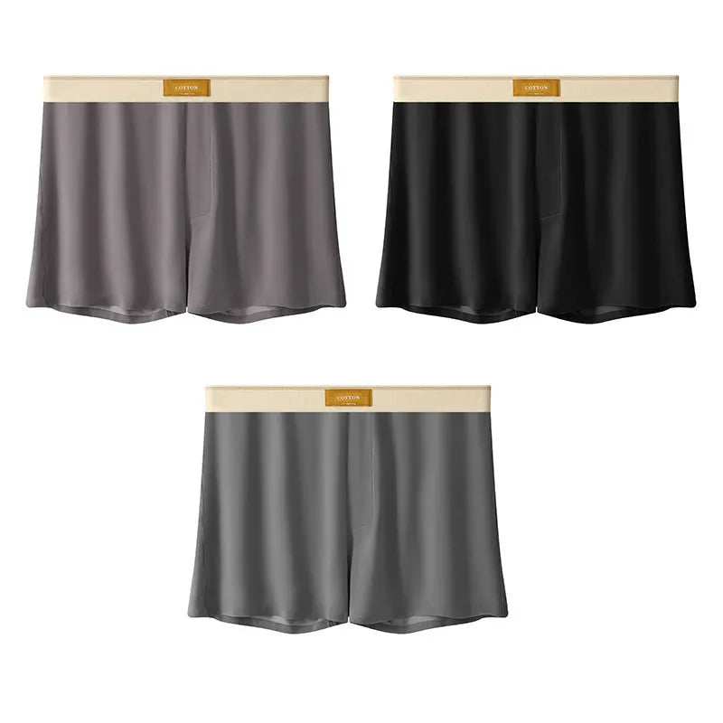 Pack of three men's solid colour loose fit ice silk underwear briefs on a grey background.