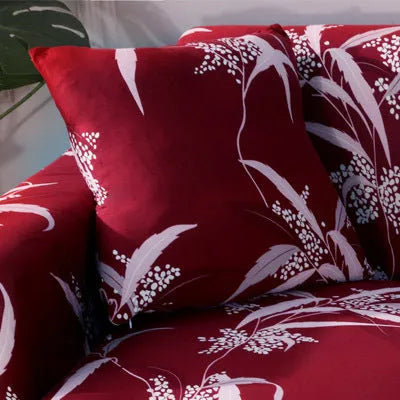 Geometric abstract printed stretch sofa slipcover covering a three-seater sofa with matching cushion covers.