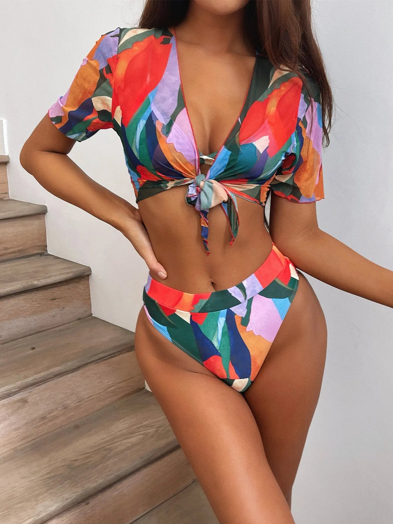 Red printed split swimsuit bikini for women on a mannequin