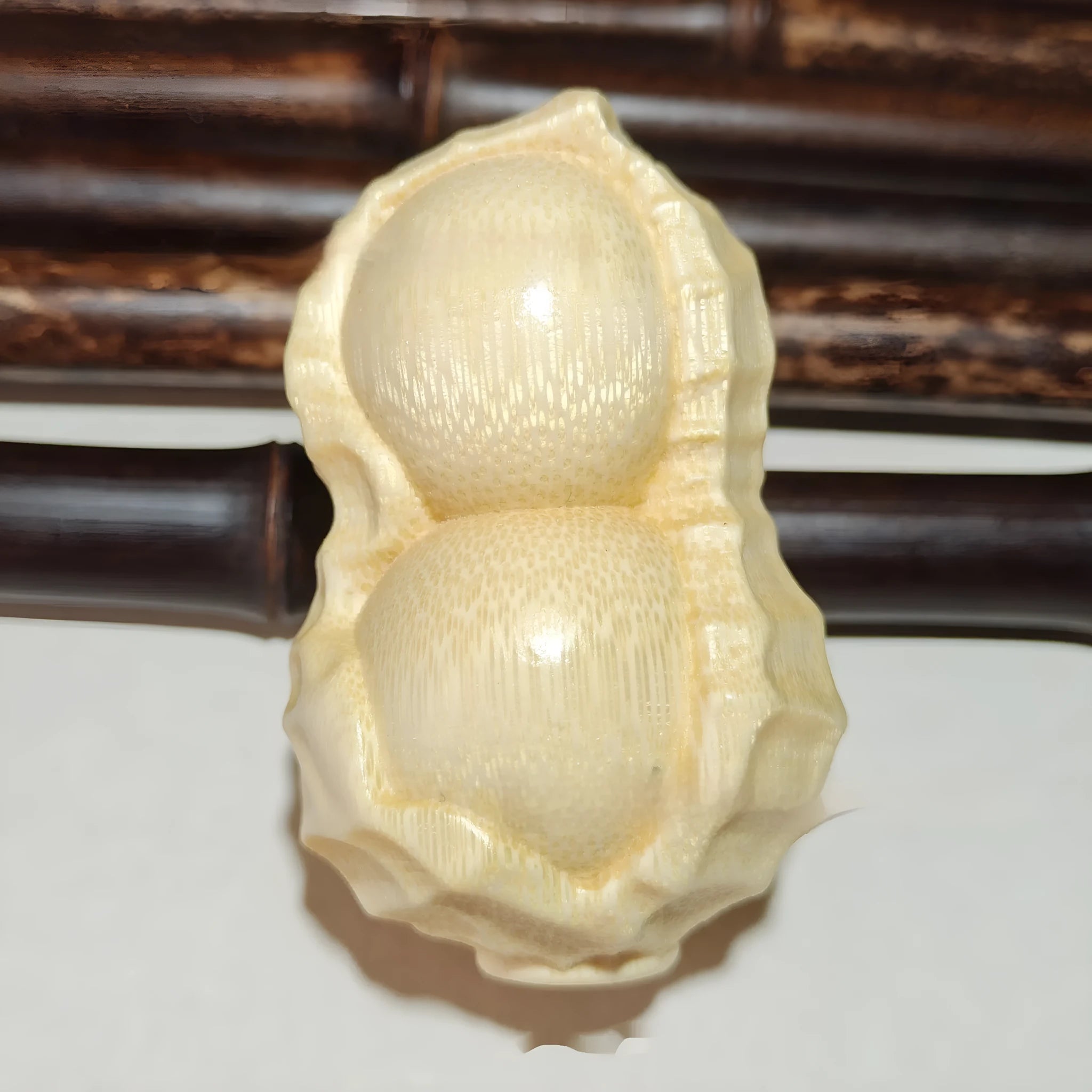 Solid bamboo carving peanut ornament with natural finish and modern simplicity design