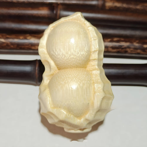 Solid bamboo carving peanut ornament with natural finish and modern simplicity design