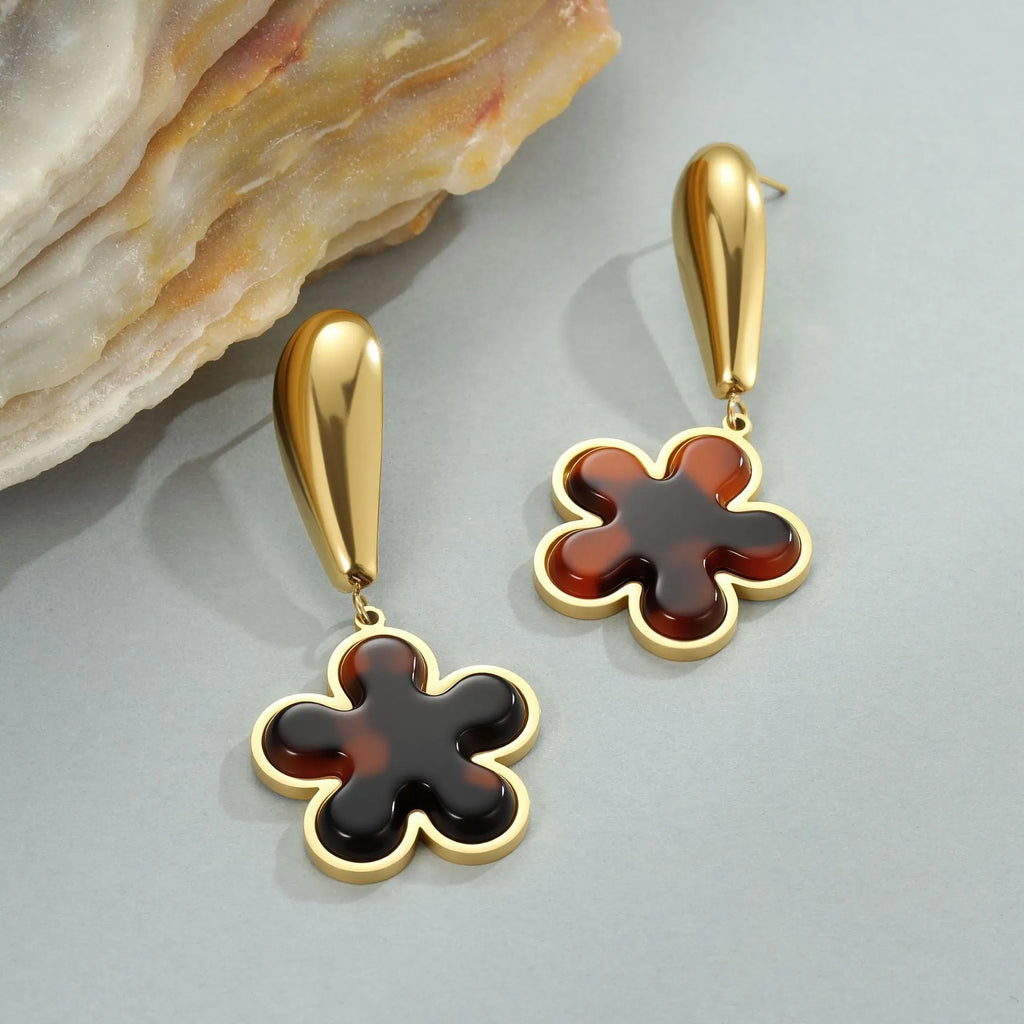 Women's tortoiseshell resin earrings in hawksbill colour with 18K gold plating showing heart and flower geometric designs