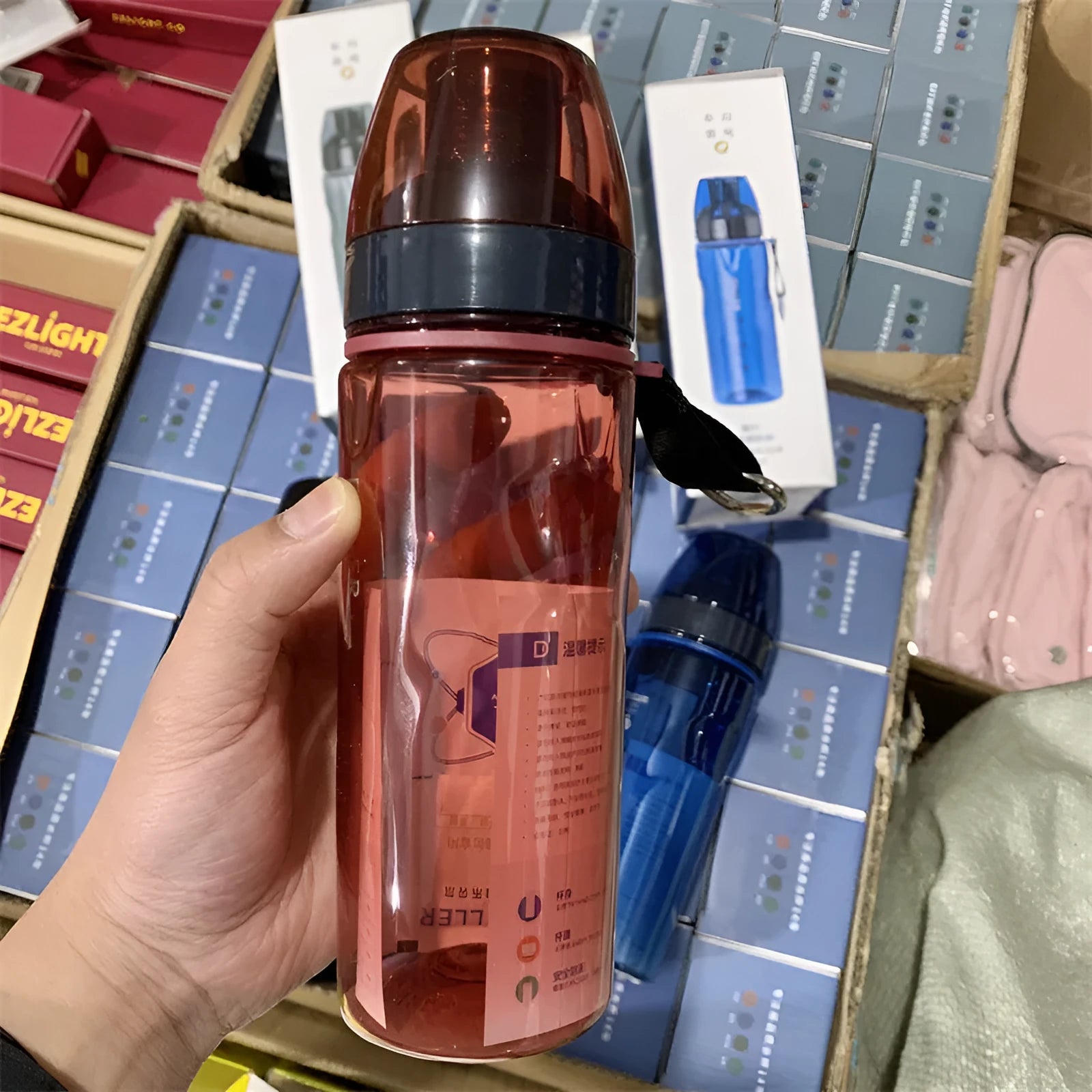 Blue Chinese-style portable water cup with a built-in tea compartment, lid, and handle.