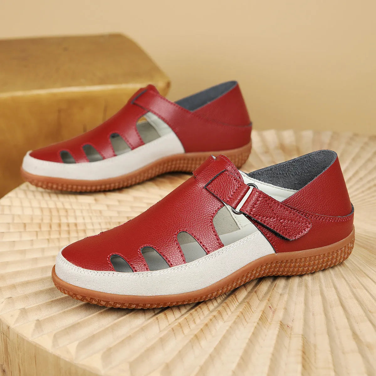 Blue plus size women's flat sandals with hollow-out design and toe cap on a thick rubber sole.