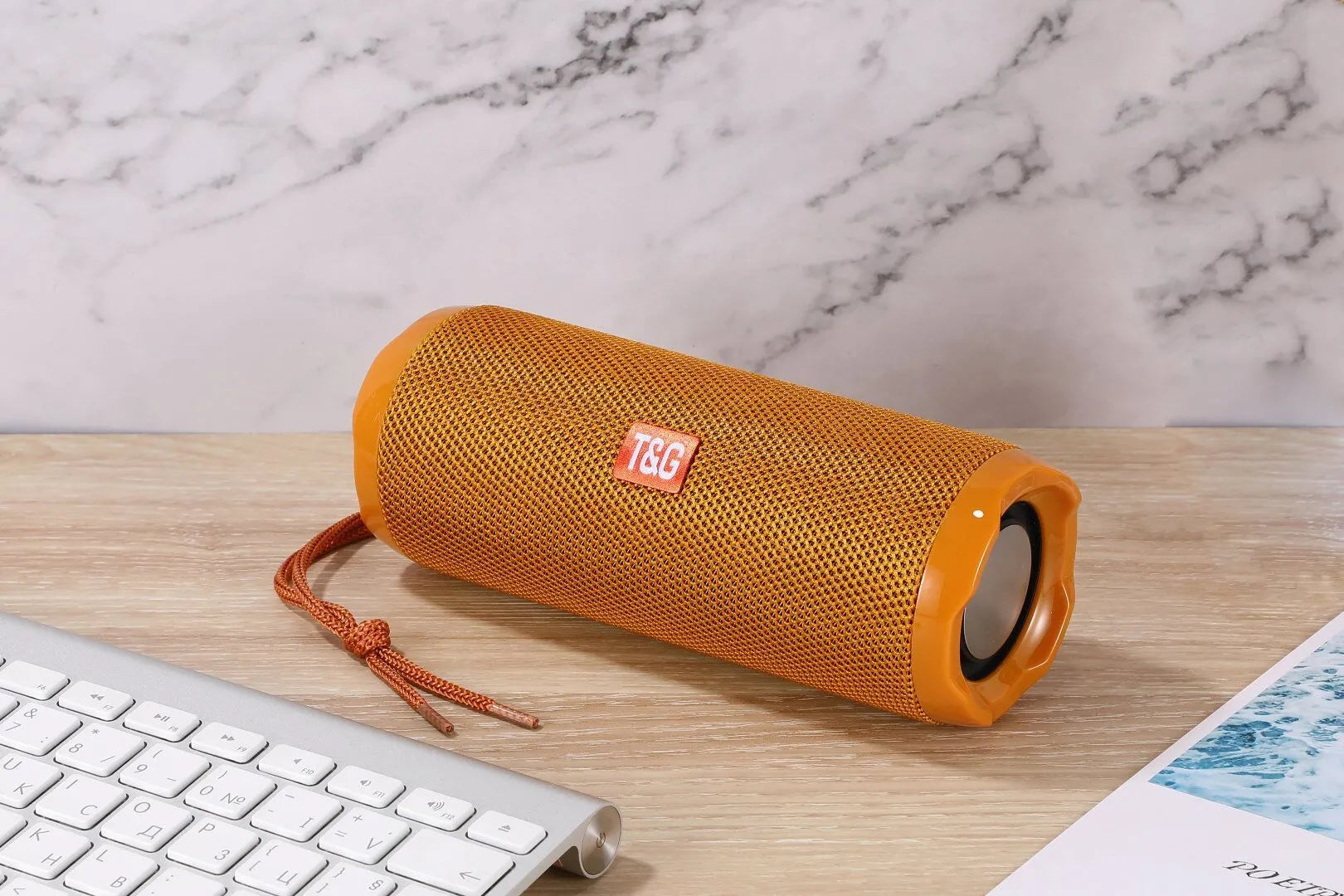 Fabric-covered portable Bluetooth speaker in multiple colours showing card holder slot.