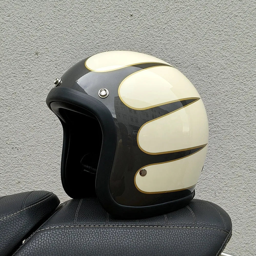 A cement grey retro-style motorcycle half helmet with a floral pattern on the side, showing its open-face design.