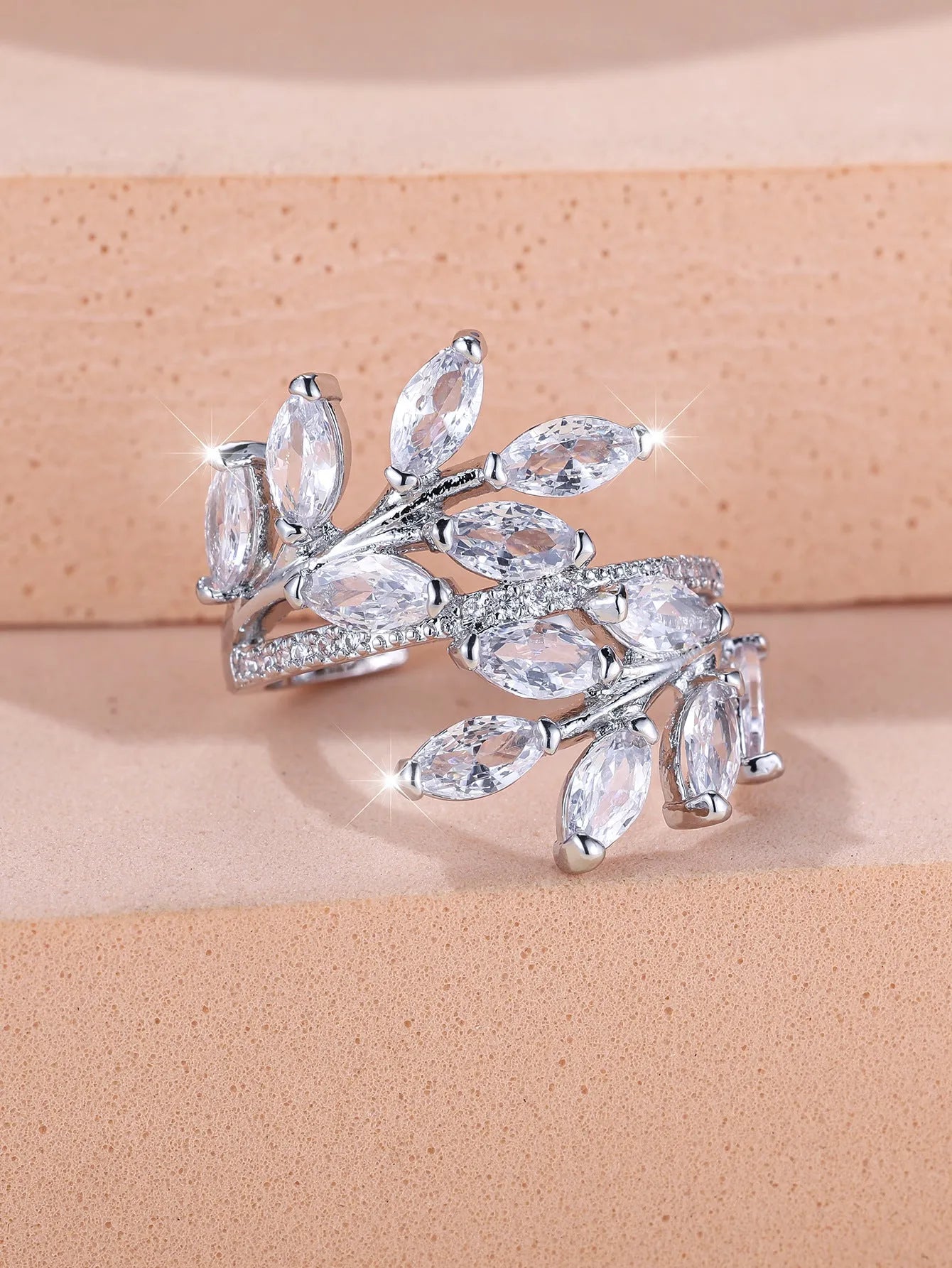 Adjustable horse eye zircon leaf ring in copper on a hand, showing leaf detail and colour options.