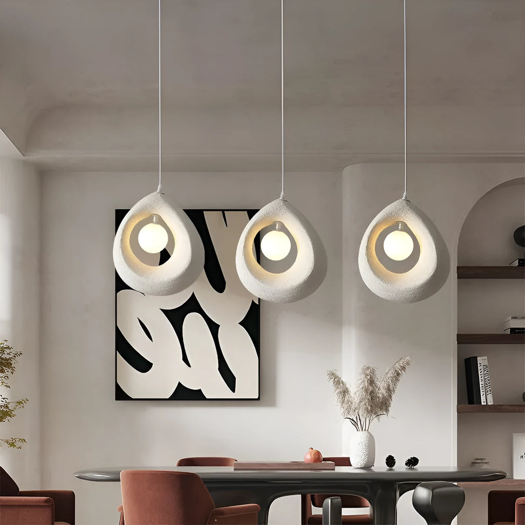 Sili Style modern pendant light with milky white glass shade in a dining room setting.