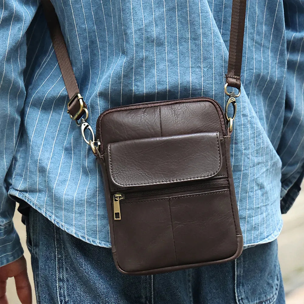 Men's brown genuine leather crossbody shoulder bag showing sewing line details.
