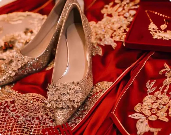 Champagne pointed-toe women's bridal shoes with floral rhinestone detail on a white background