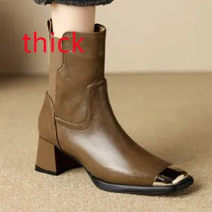 Brown cowhide leather Martin boots with side zip and high heel on wooden floor