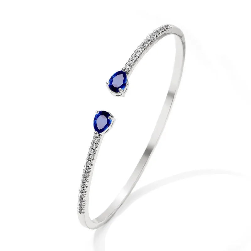 Copper bracelet with zircon inlay in white or blue colour simple design