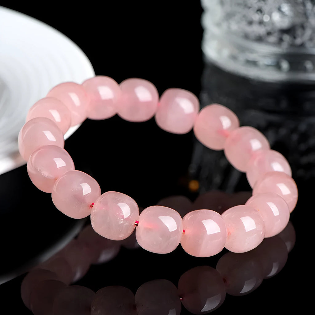 Natural pink crystal barrel bead bracelet with 8x10mm geometric beads on wrist