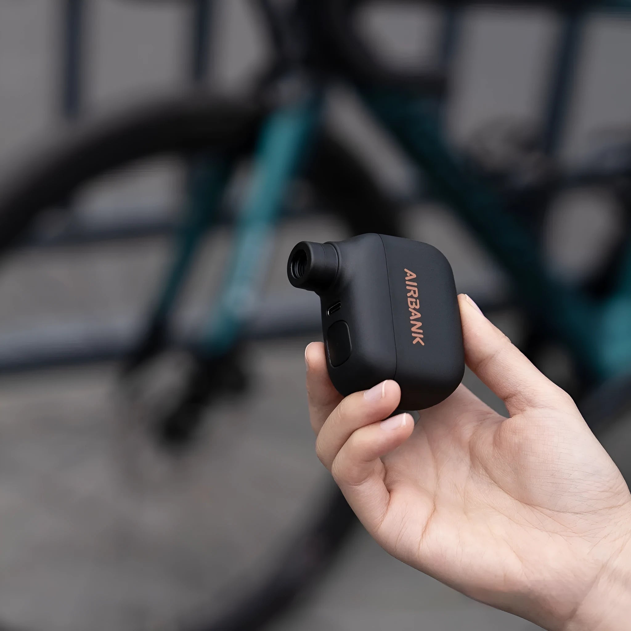 Black plastic electric bike pump with USB charging port and waterproof storage bag