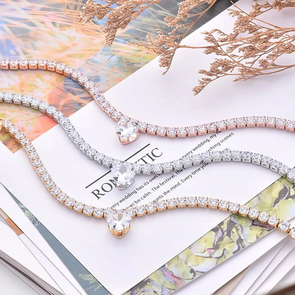 Gold rhinestone heart design pet collar for cats and dogs on a white background.